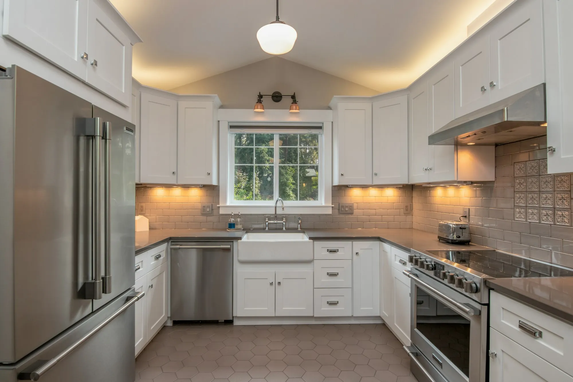 A finished kitchen with under-cabinet lighting switched on