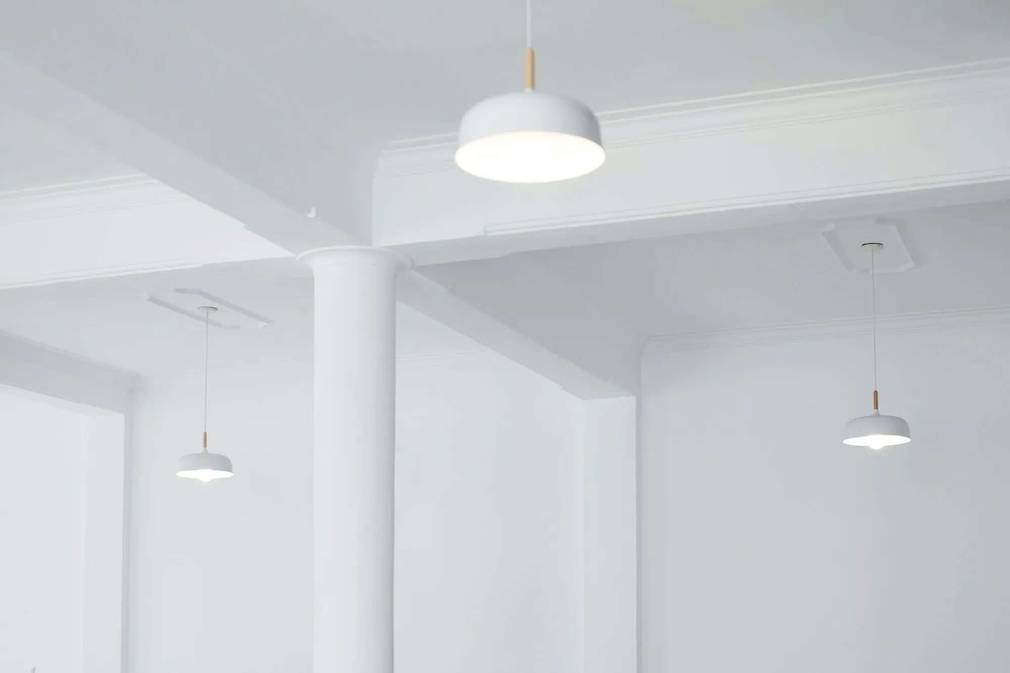 Pendant lights hanging in a bright residential room