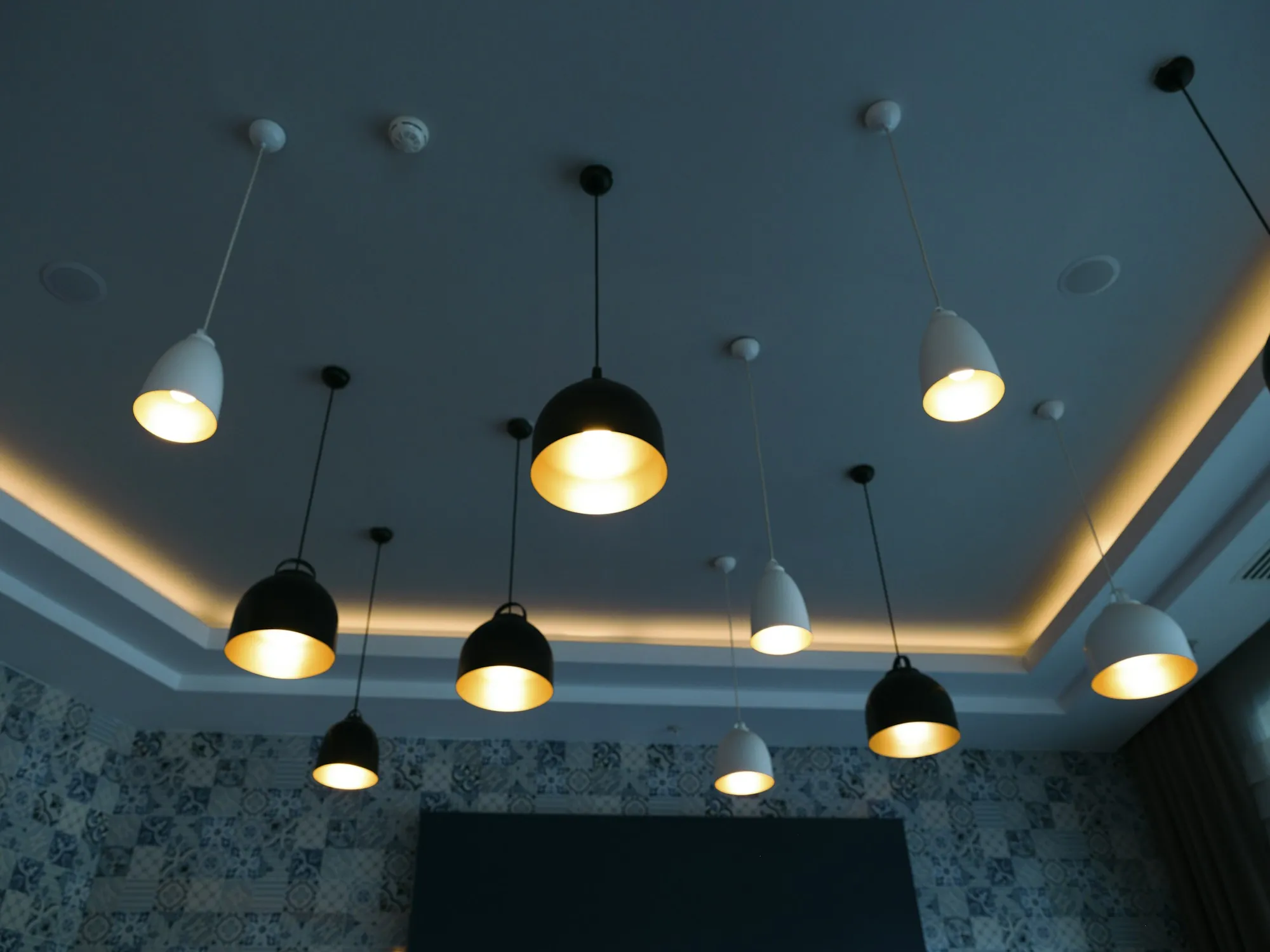 A cluster of pendant lights above a residential dining area